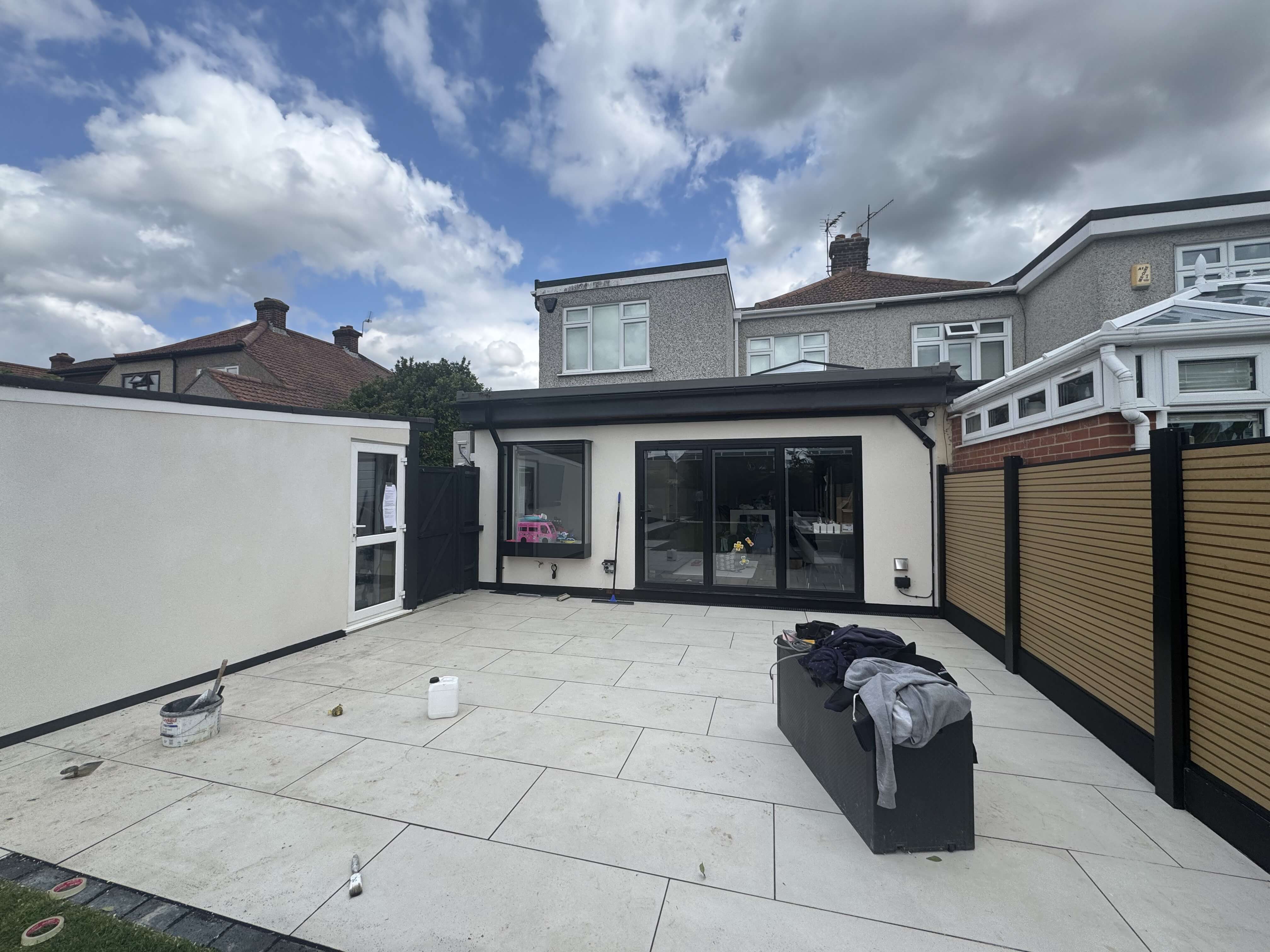 Modern rear extension on a 1930s semi-detached home in Bexley with white render and full-width sliding doors